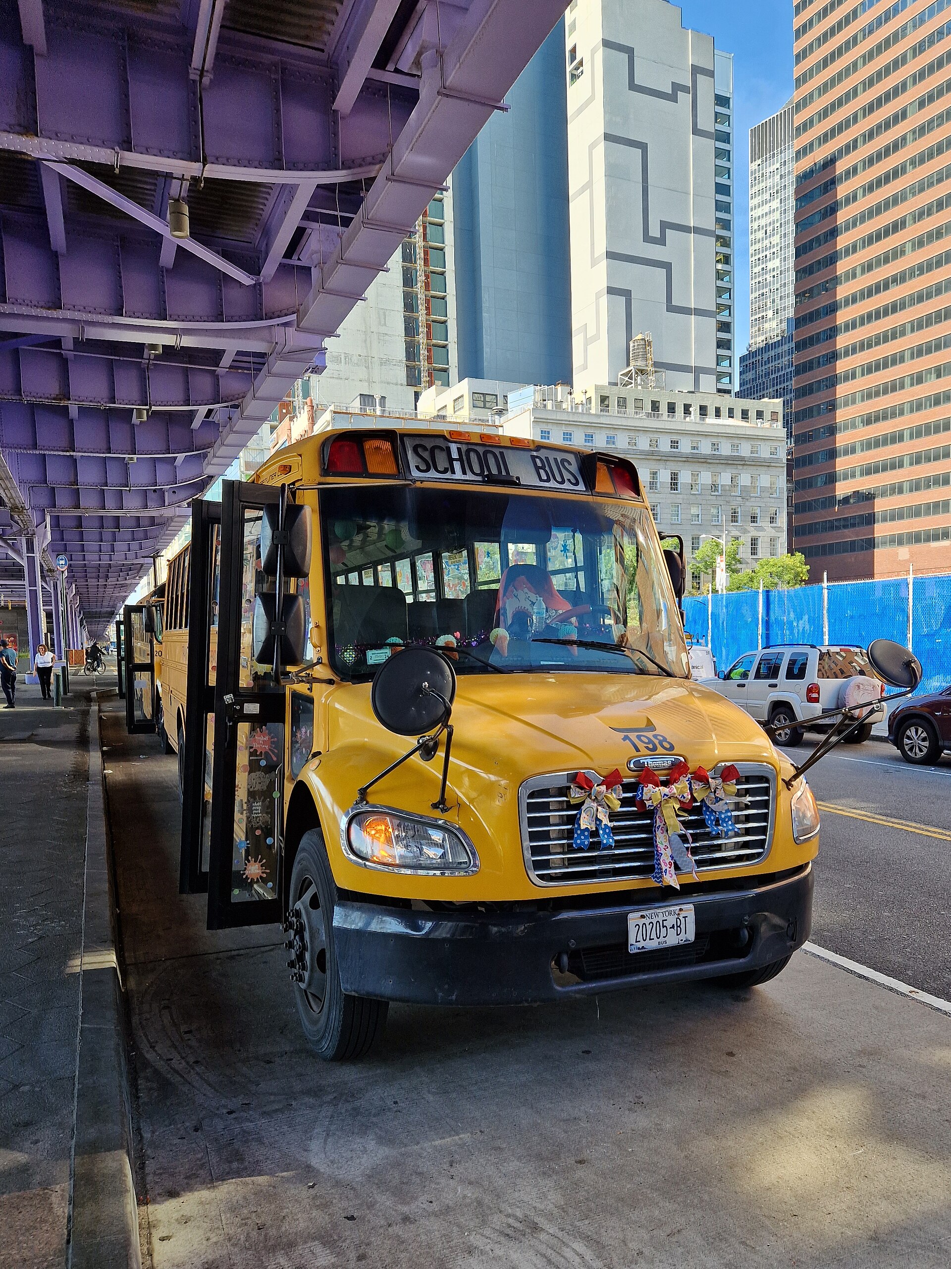 A yellow school bus on a street in Manhattan, New York City