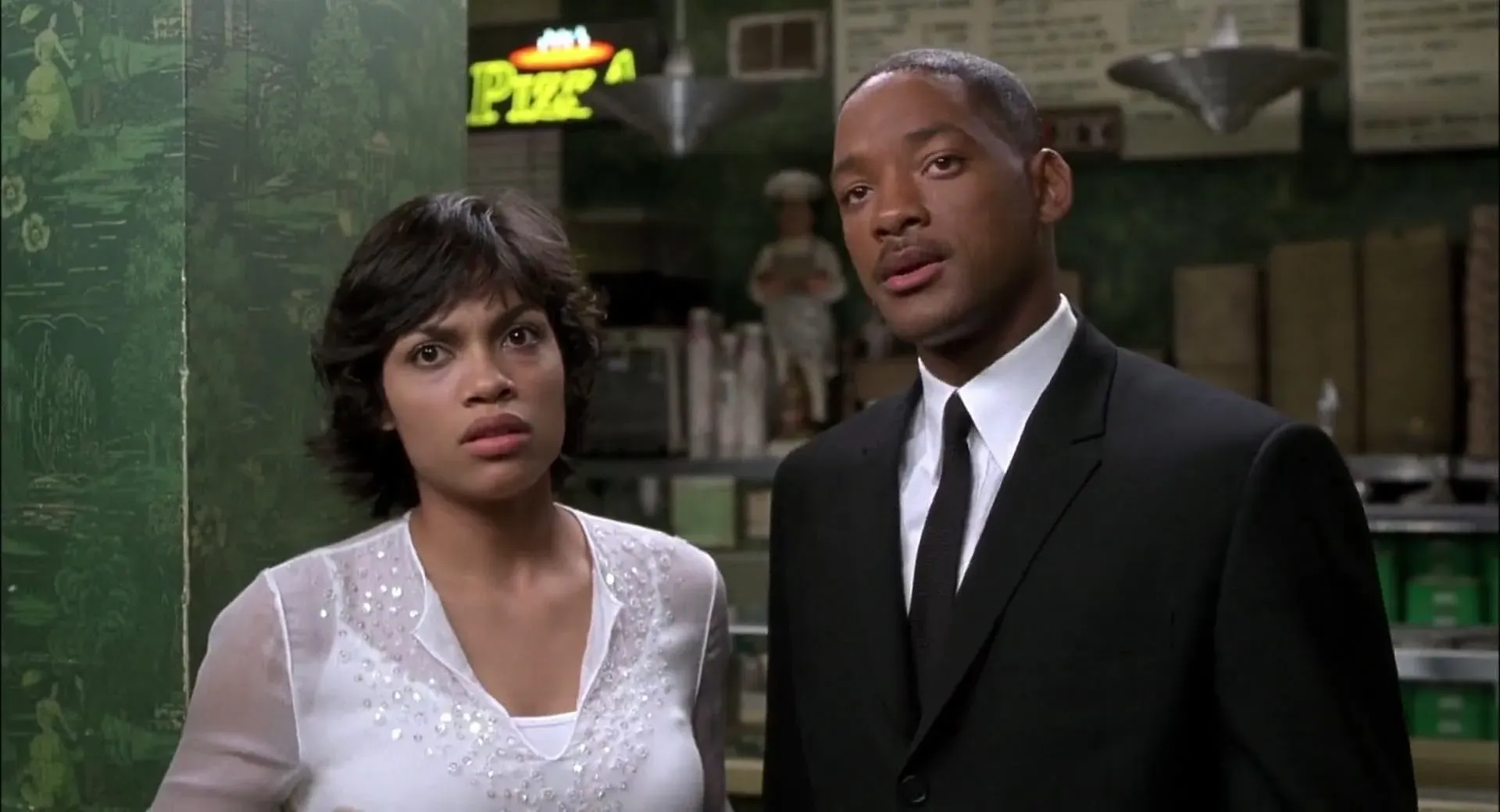 Rosario Dawson as Laura Vasquez standing beside Will Smith as Agent J in Men in Black II