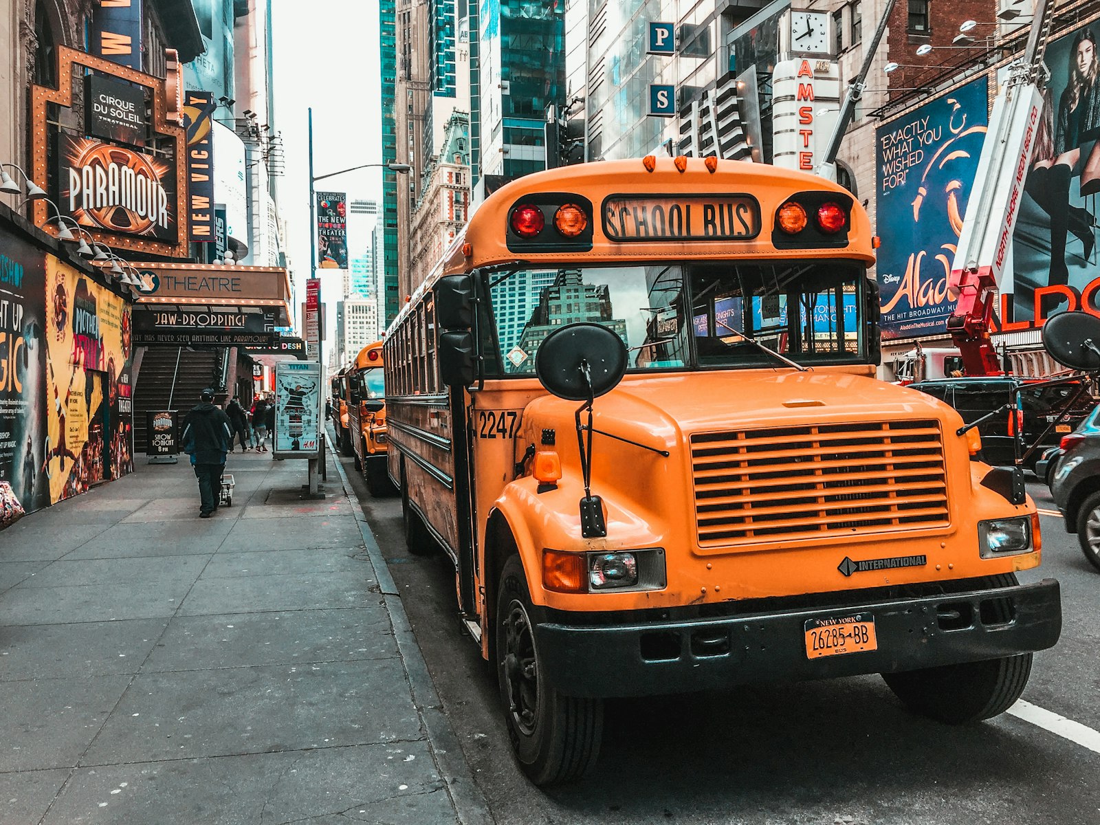 A yellow school bus on Broadway in New York City